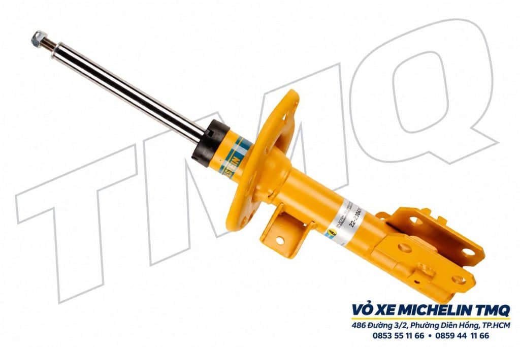Phuộc Bilstein B6 trước màu vàng, có bát đỡ lò xo và watermark TMQ